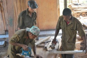 Young men using carpentry tools